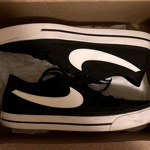 Nike sports shoes.  Bought wrong size and wore them once outside.